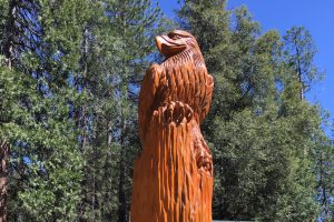 Wood Carved Bird Resting on Wood