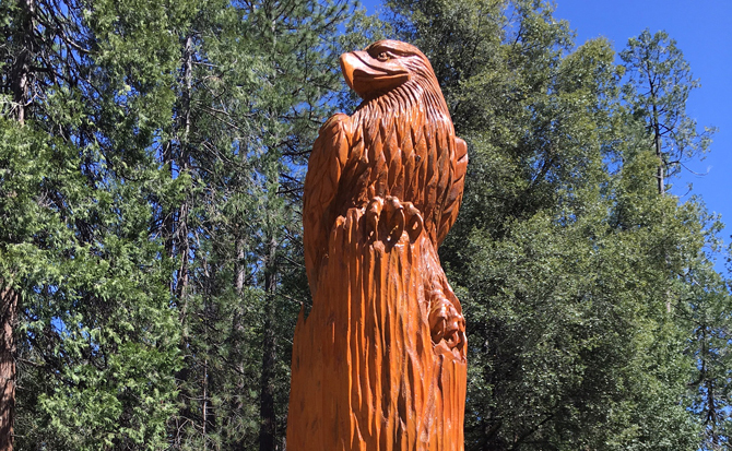 Wood Carved Bird Resting on Wood